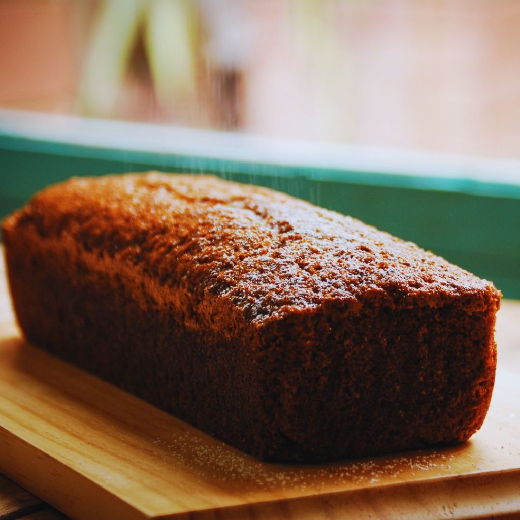 banana bread sitting on a wooden cutting board